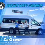 Happy customers standing smiling in front of the silver Cargo Van iat STLCarZ lot