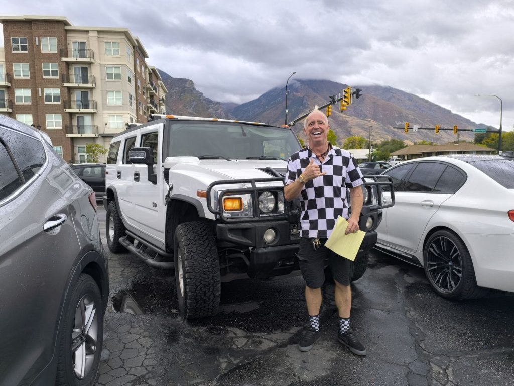 Man in front of his new Hummer H2 in Provo, Utah