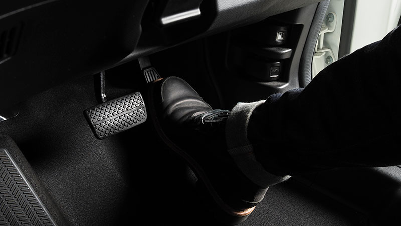 Close up the foot pressing foot pedal of a car
