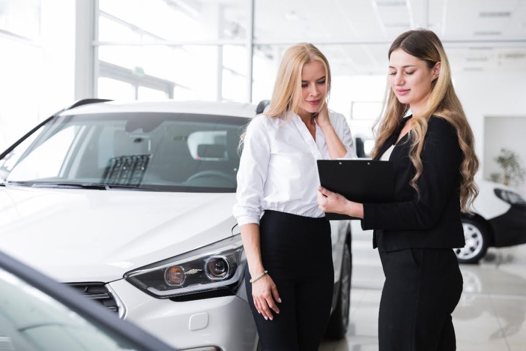 A car dealer showing a client warranty offers