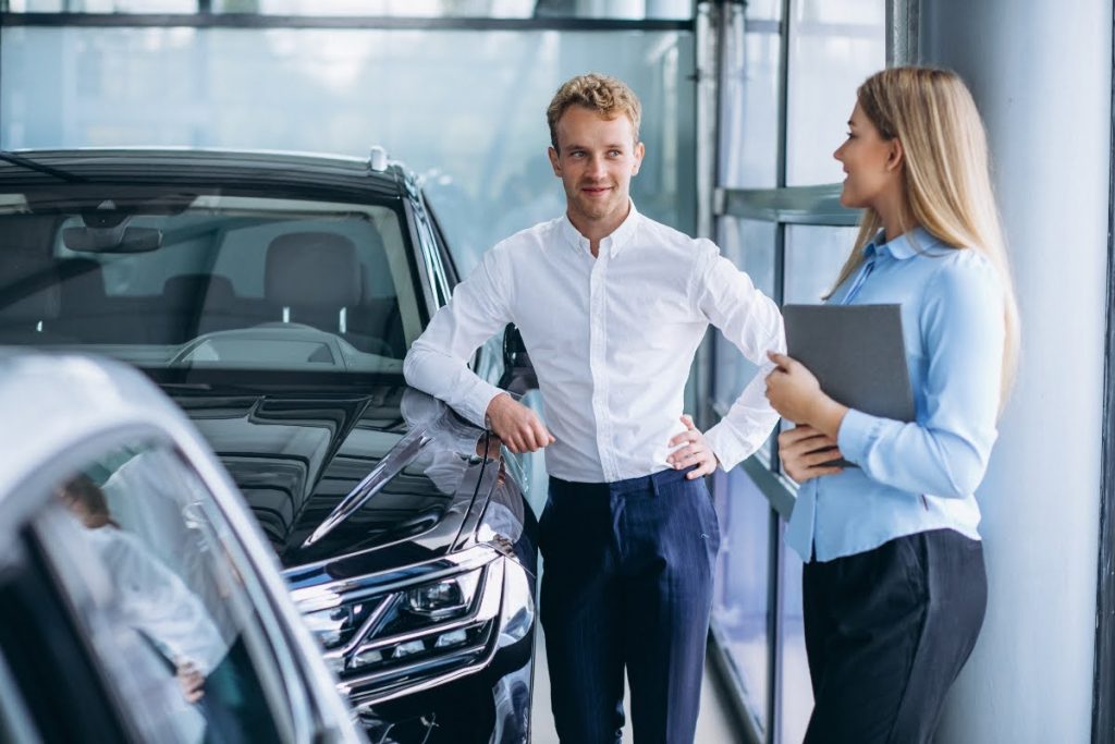 A man buying a car from a dealer