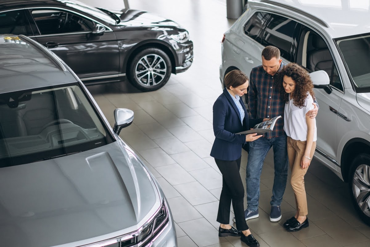Clients discussing the NADA used car value with the salesperson