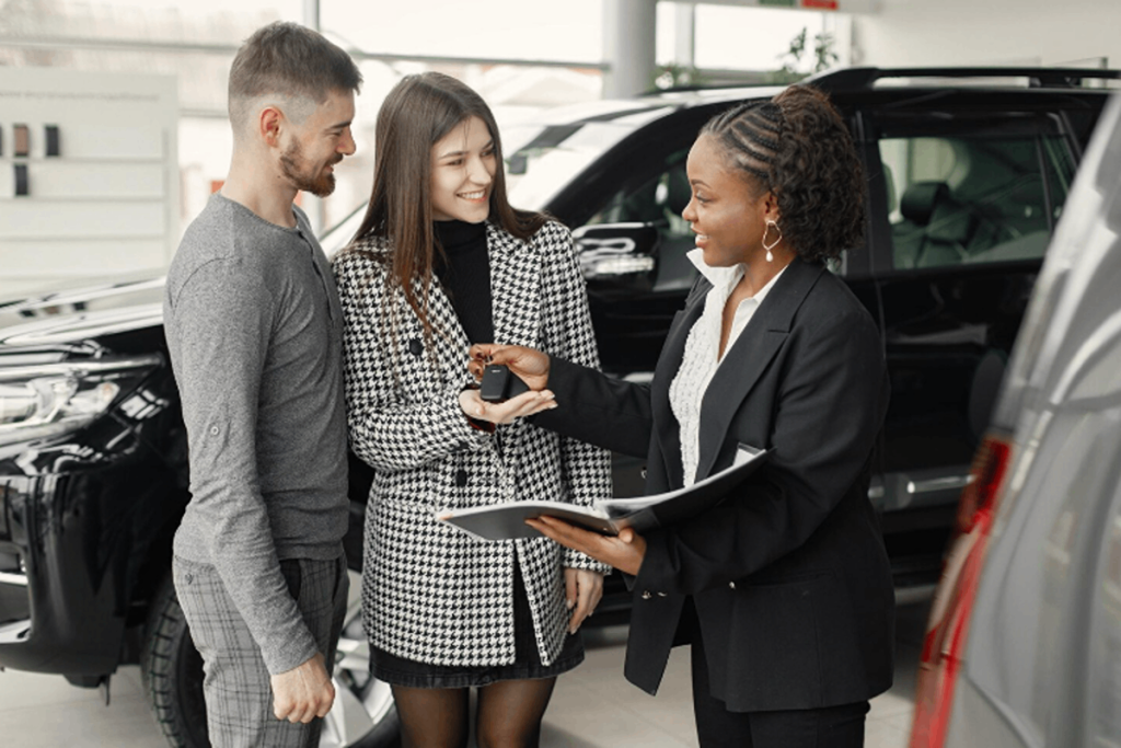 Couple buying a used car in the car shop