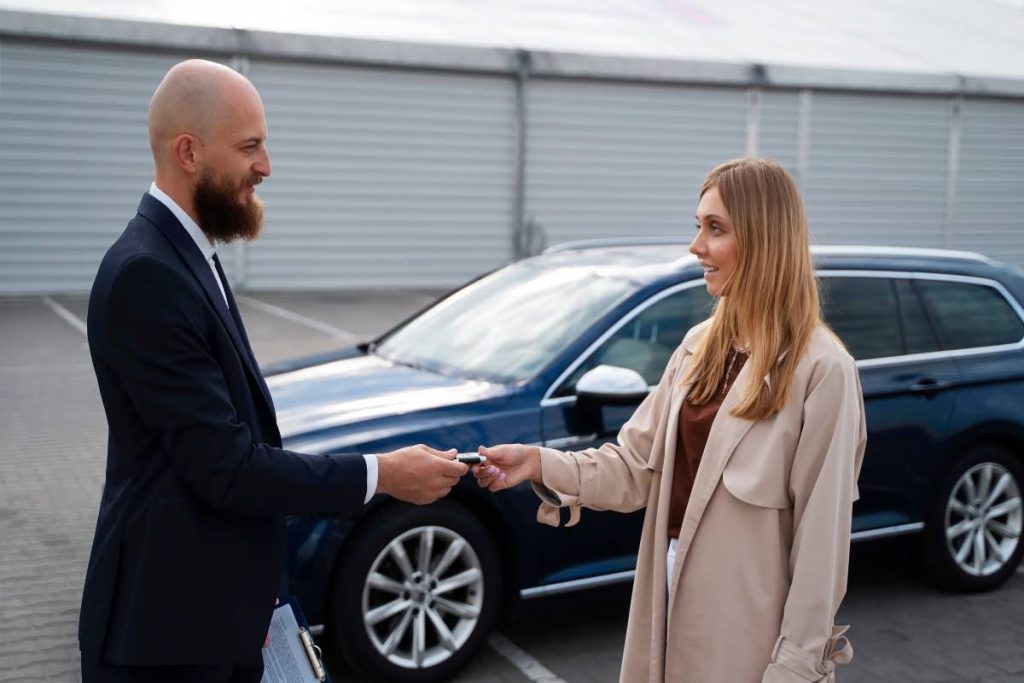A woman buying a used car in a dealership