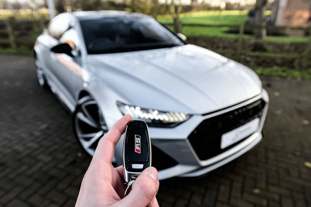Man getting the keys to the used car he bought