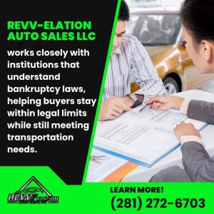 Two individuals discussing car financing paperwork, illustrating how REVV-elation Auto Sales LLC works with institutions to ensure compliance with bankruptcy laws for car buyers