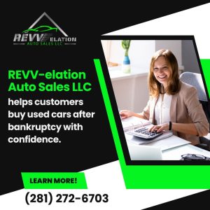 Smiling woman at desk, symbolizing REVV-elation Auto Sales LLC empowering customers to confidently buy used cars after bankruptcy
