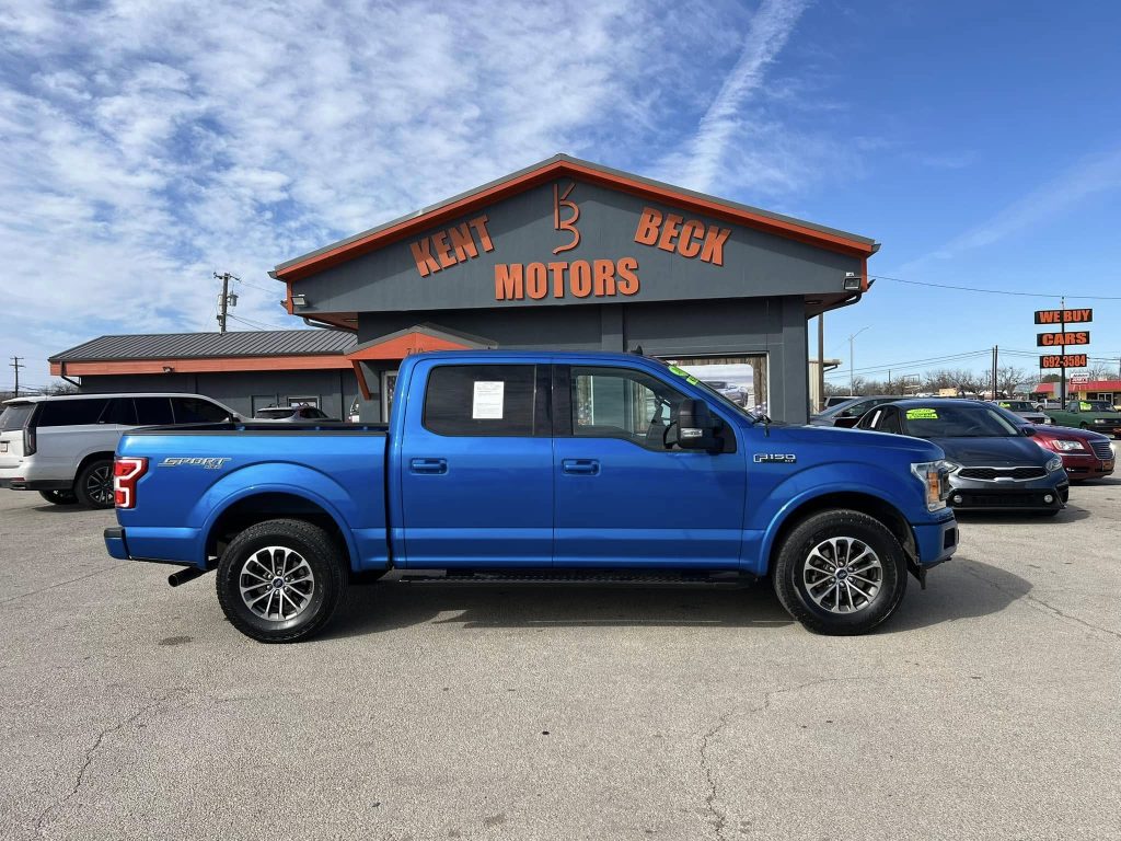 2019 Ford F150 Sport used blue truck in Abilene, TX in front of Kent Beck Motors car dealership