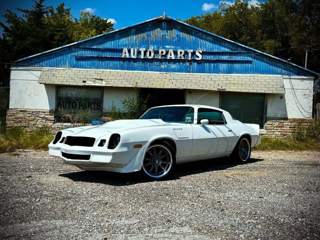 535073850_18525658303041971_1213091878268912464_n Classic white Camaro outside auto parts shop at Dollar Sharp Motors