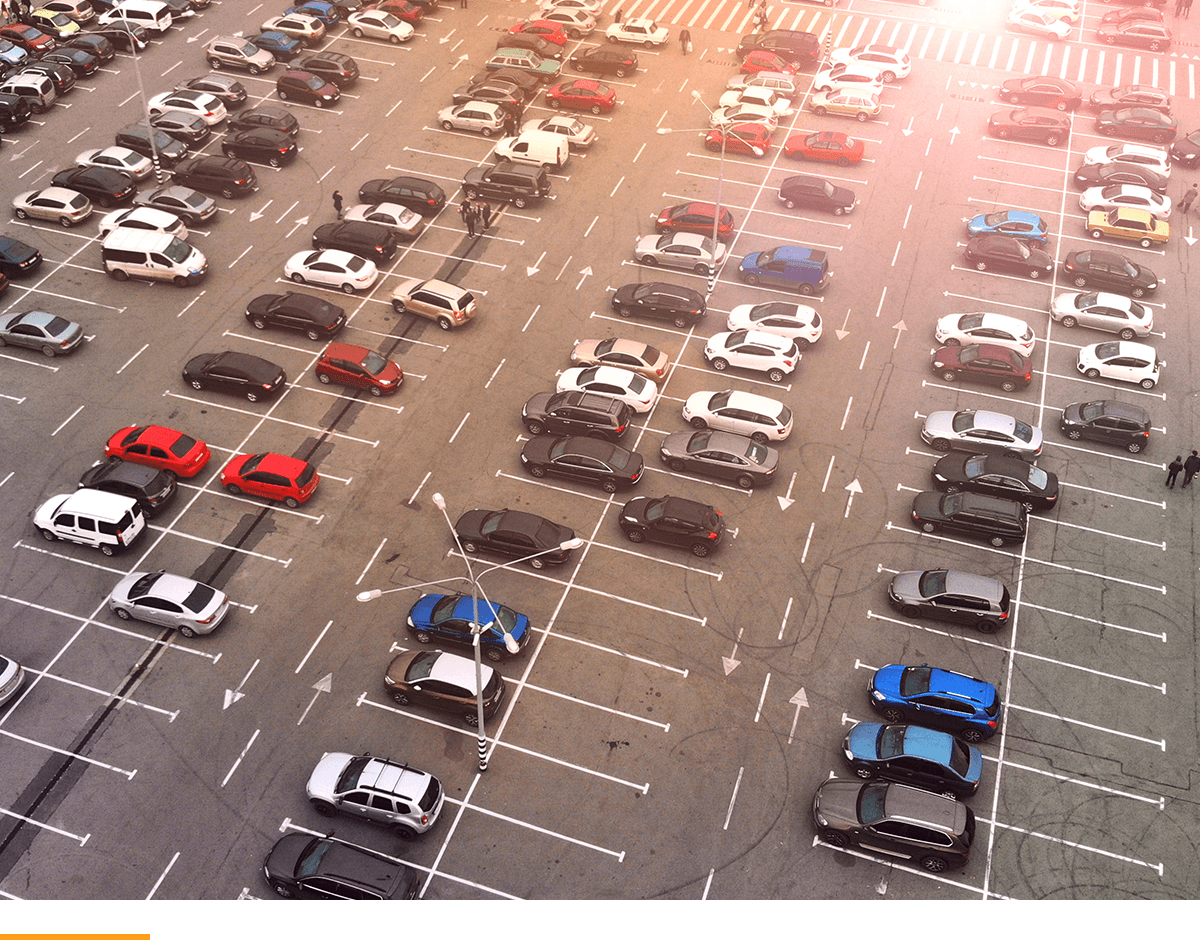 Multiple cars parked in a used car lot. 