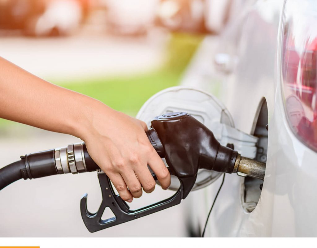 A person at the gas station refueling.