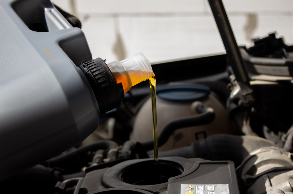 Motor oil being poured into an engine.