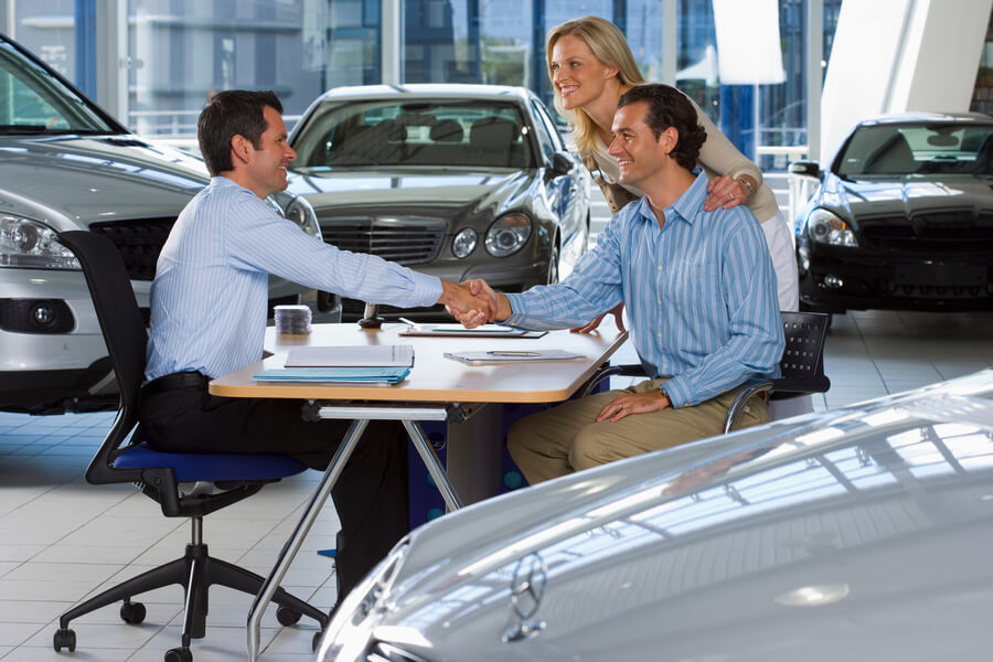 Income tax refund advance - Car sales discussion inside a dealership.
