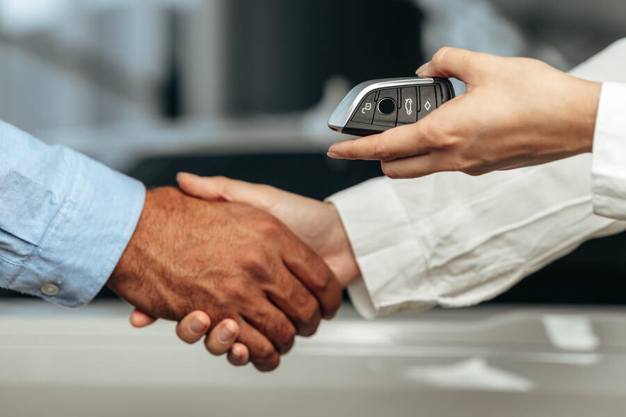 Income tax refund - Handshake while exchanging car keys.