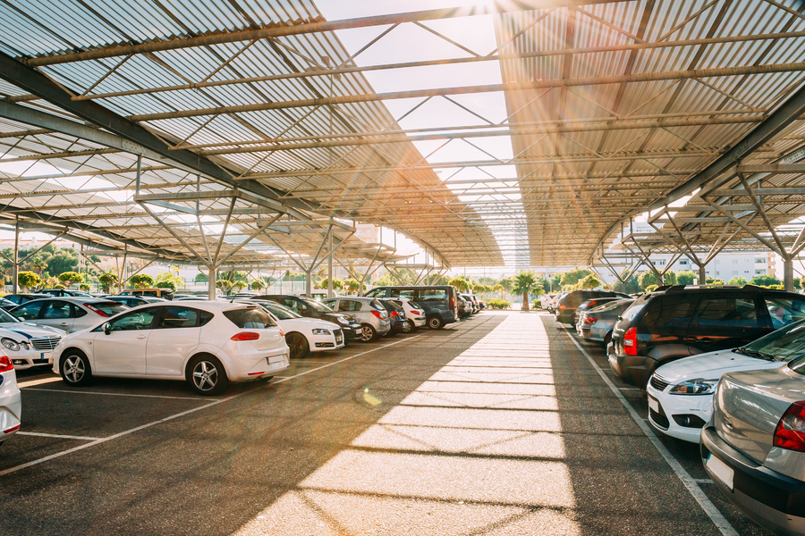 Cars parked inside a covered parking garage.