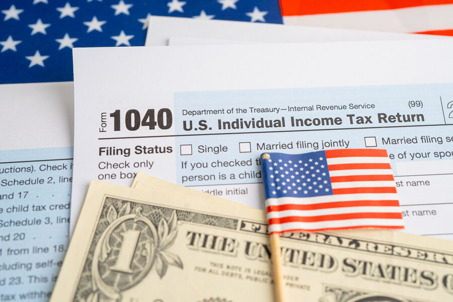 Is income tax refund considered income - U.S. tax return form with dollar bills and an American flag.
