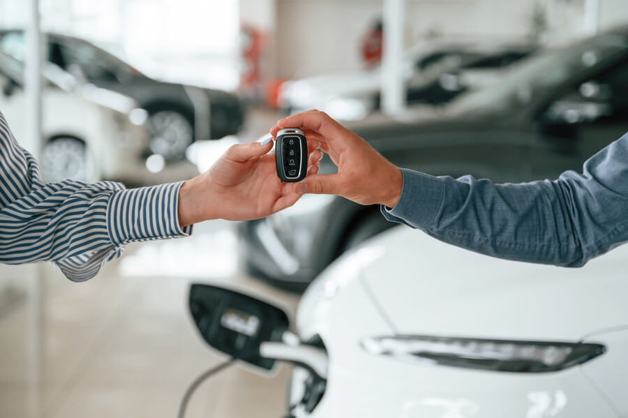 Handing over car keys at a dealership.