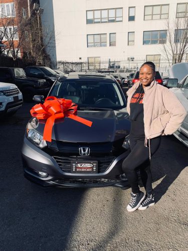 638811096918055012 Happy customer picking up her new vehicle at Genesis Auto & Truck Sales in Newark, NJ