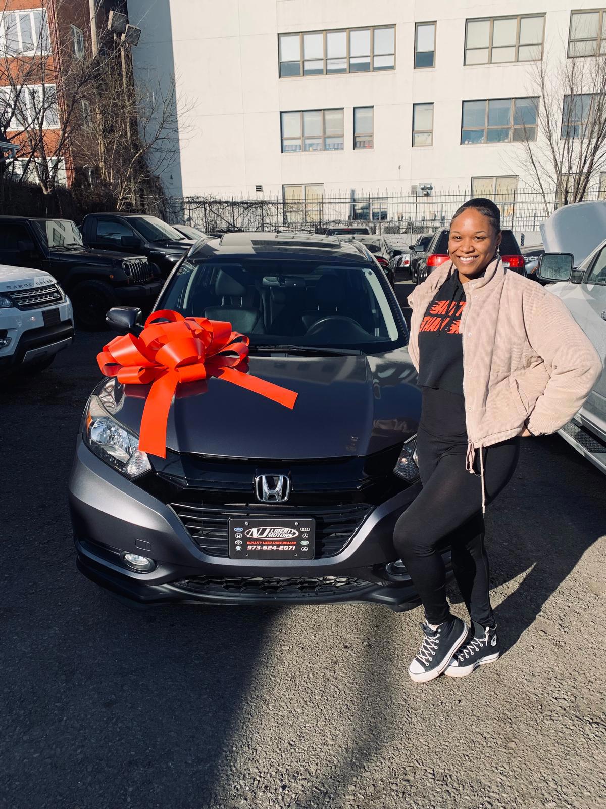 638811096918055012 Happy customer picking up her new vehicle at Genesis Auto & Truck Sales in Newark, NJ