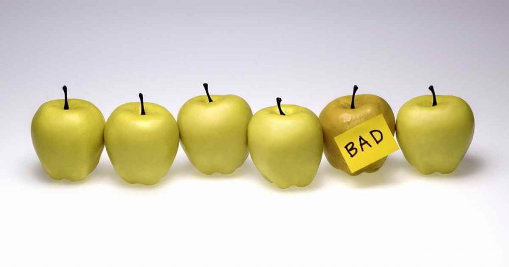 a row of apples with one discolored that reads "bad"