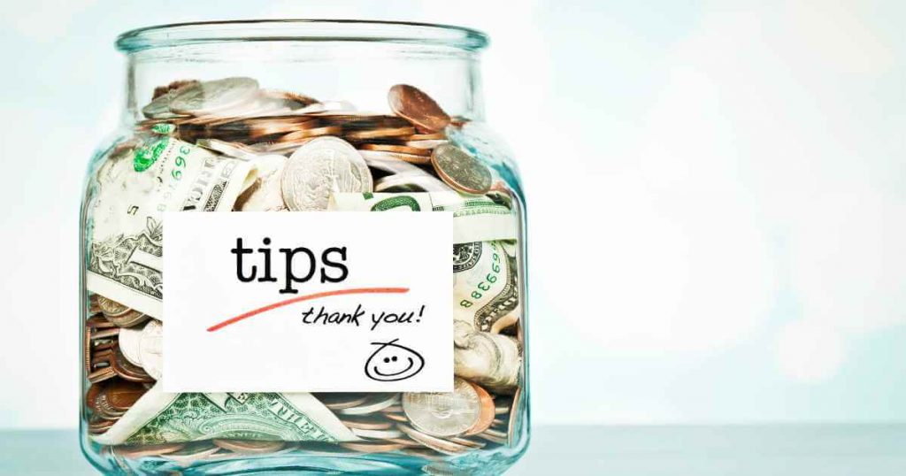 a jar of money that reads "tips" to improve your credit score