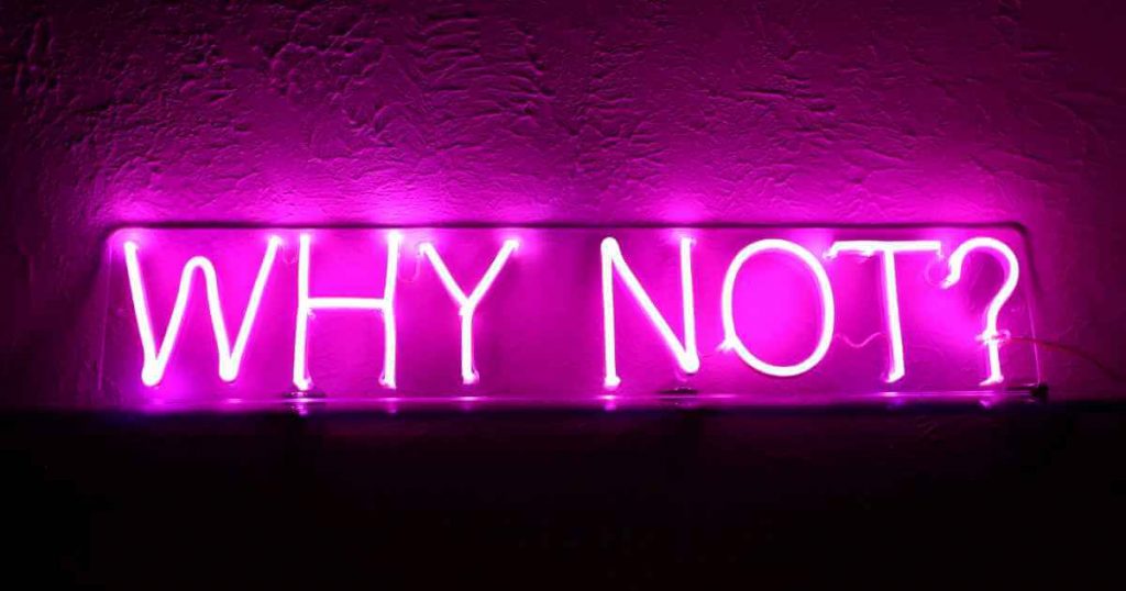 a neon sign that reads "why not?