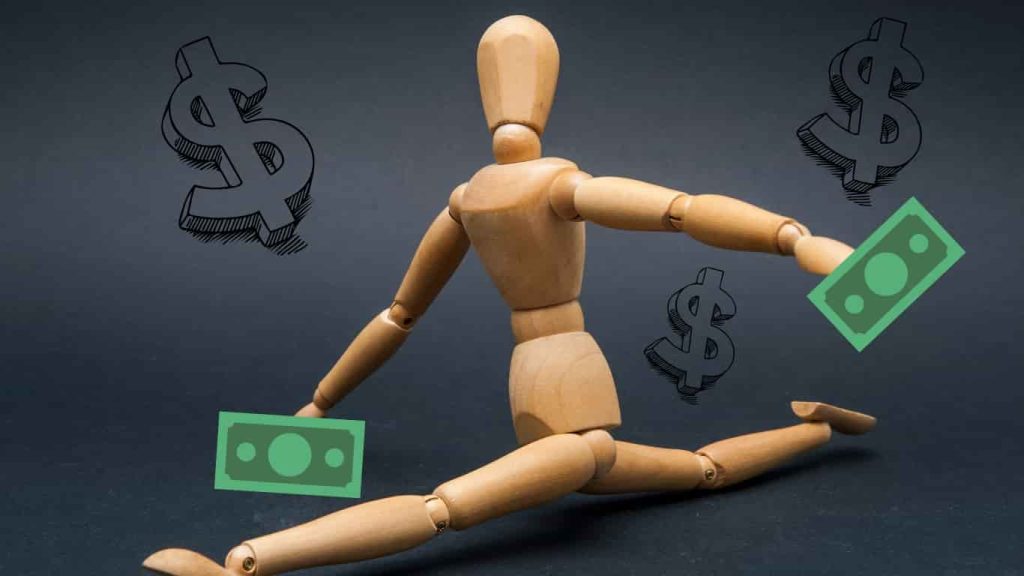 a wooden doll does the splits as it holds dollar bills in its hands representing the flexible financing options with a local in house dealership