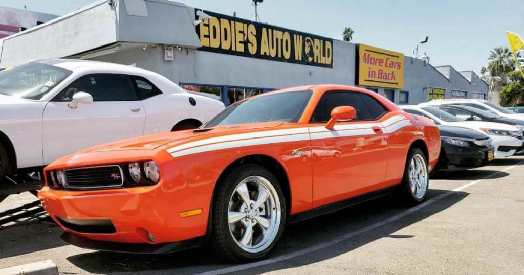 an image of a car in front of Eddie's Auto World, a car lot fresno has available