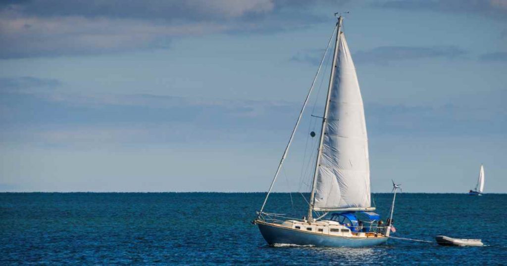 a sailing boat out at sea depicting smooth sailing