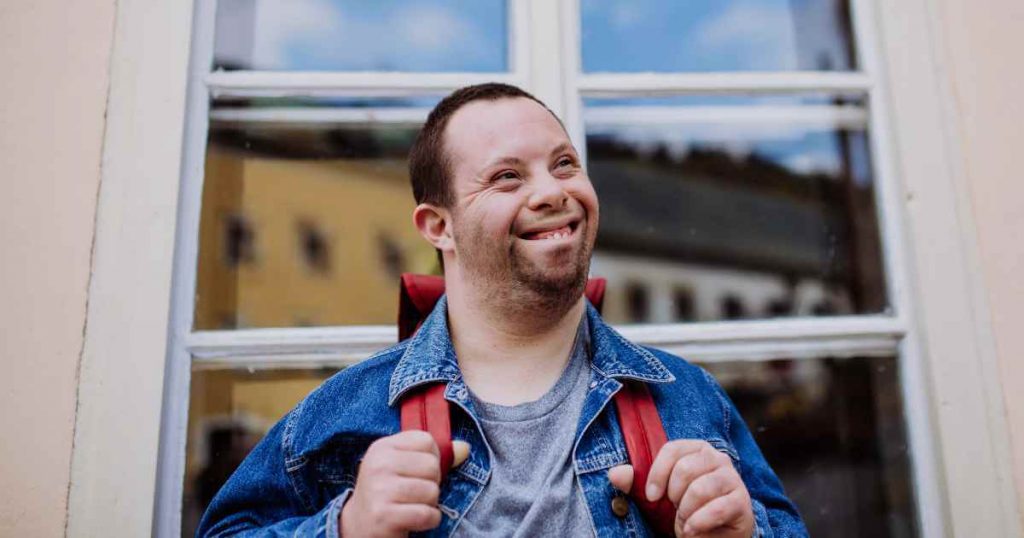 A man smiling brightly as he weighs all the benefits of low down payment cars for sale