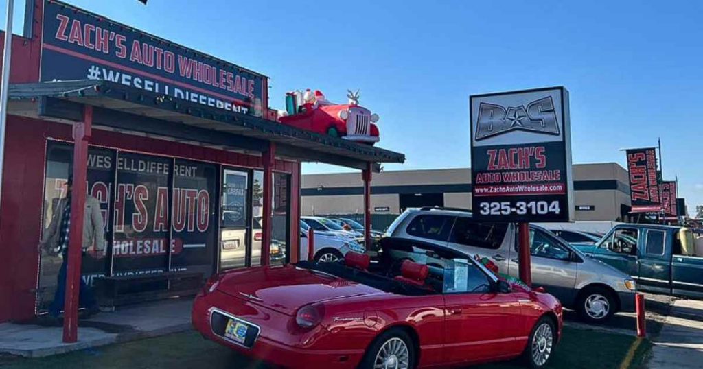 a red car in front of Zachs Auto Wholesale