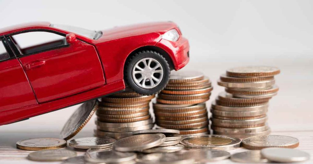 an image of a toy car climbing coins depicting paying and increasing credit at a buy here pay here auto sales