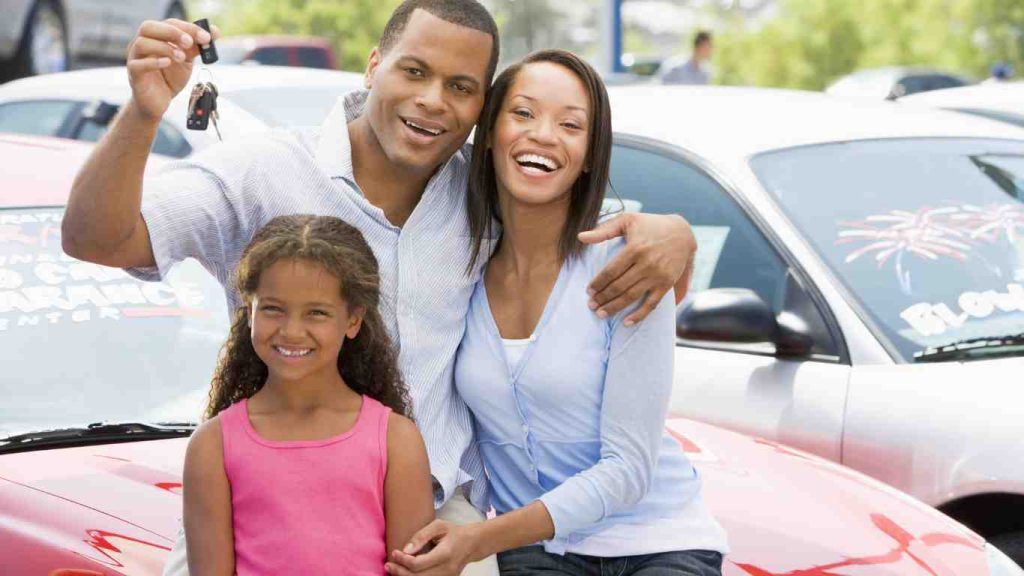 a happy family after purchasing a buy here pay here used cars for sale