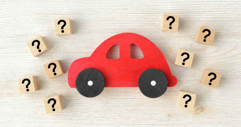 image of a red toy car with question marks all around it