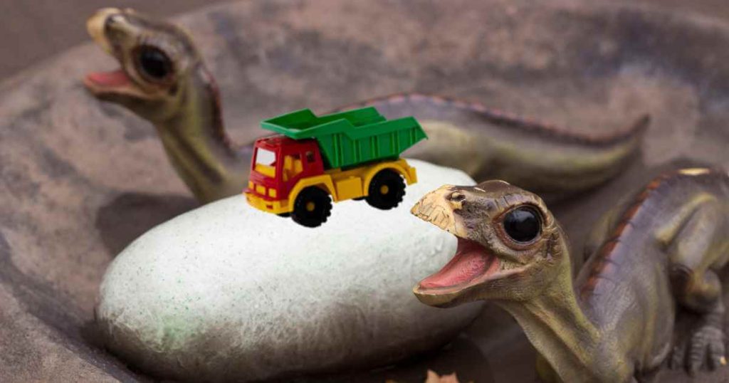 an image of baby dinosaurs recently hatched begging for food next to a little toy car