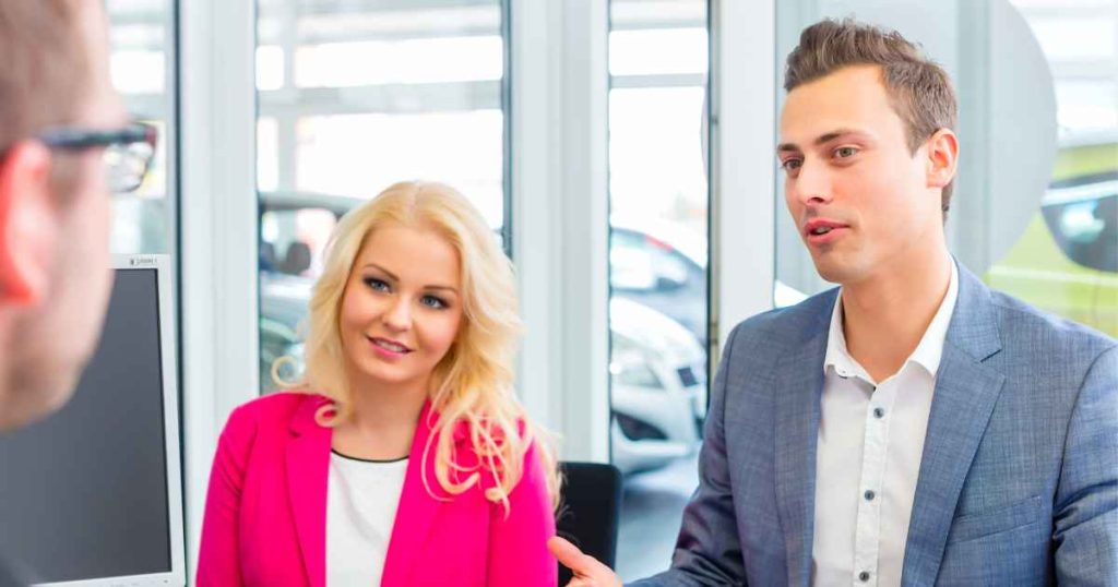 an image of a man and woman negotiating a deal for a used car fresno