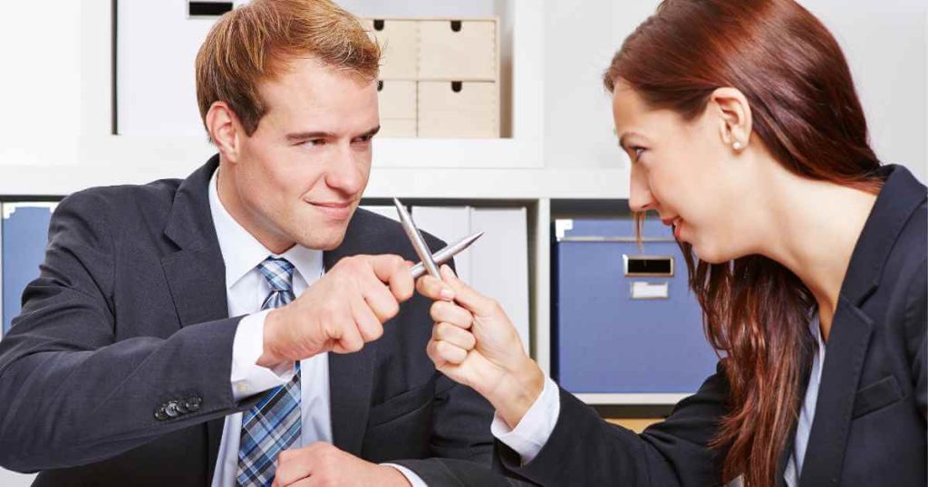 a photo of a man and woman crossing pens as if dueling for car financing options