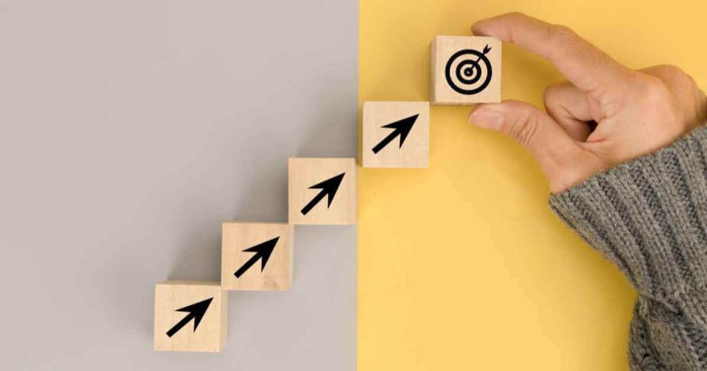 wood blocks with arrows up to a target signifying a strategy for car taxes