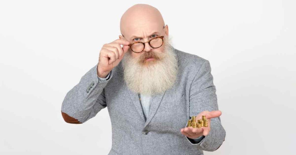 a photo of an older man with a long beard holding his hand out with coins