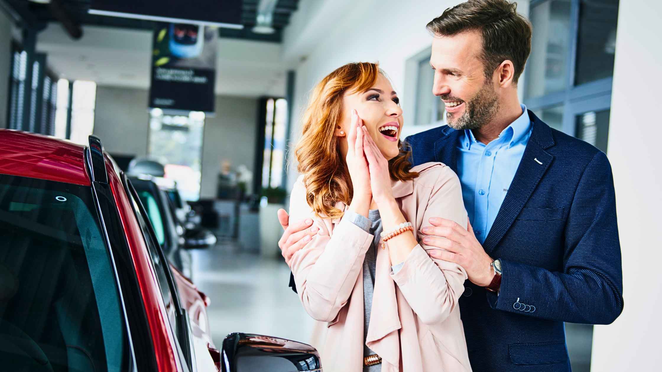 a photo of a happy man and woman after buying their used car fresno