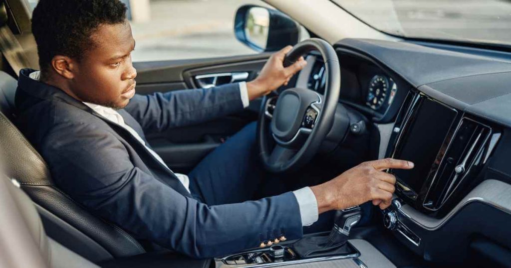 a man touching a button on one of his newly purchased used cars for sale fresno