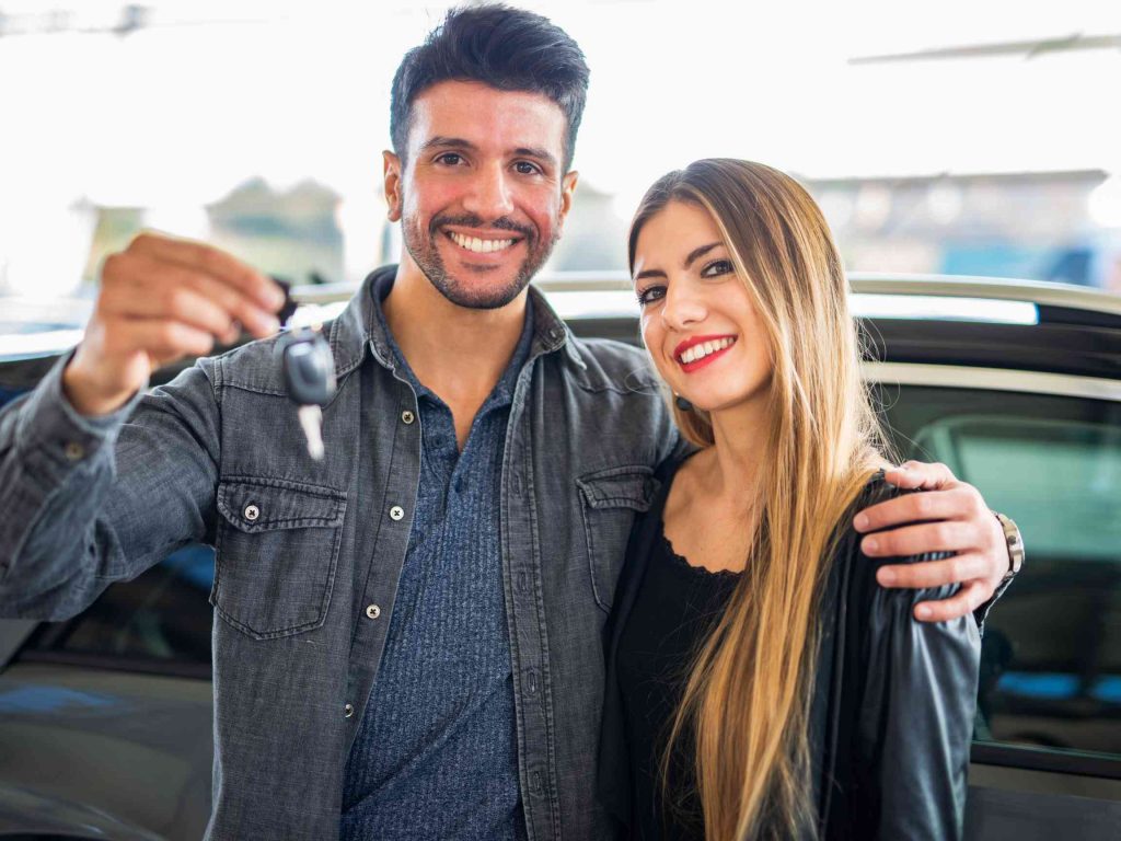 a couple very happy after buying used cars
