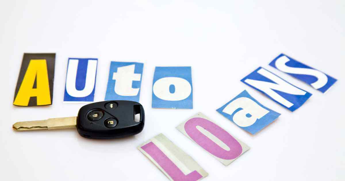 a car key with cut out letters of a magazine that read "auto loans near me"