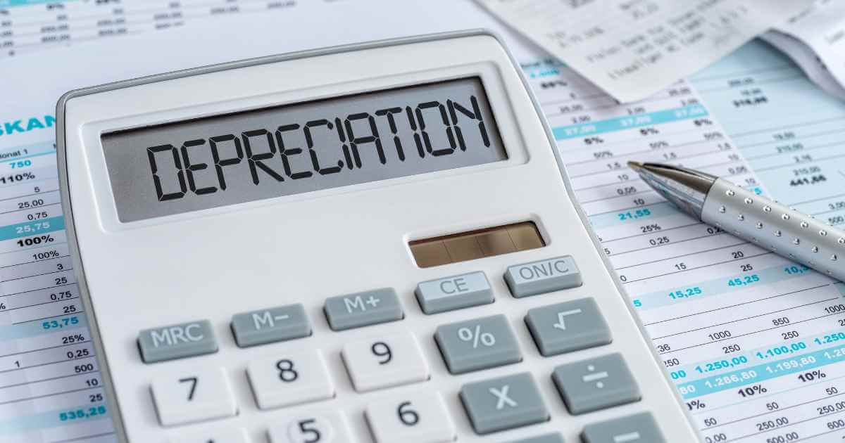 a calculator on top of paperwork with the word "depreciation" on it referring to car depreciation
