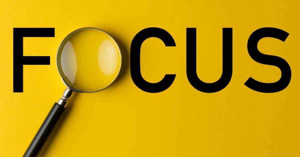 the word "focus" with a magnifying glass over the O showing you to focus your attention on car loan APR
