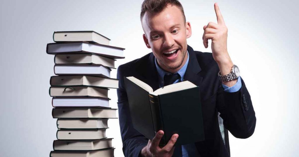 a man reading a book and exclaiming as if he's had a revelation about car depreciation