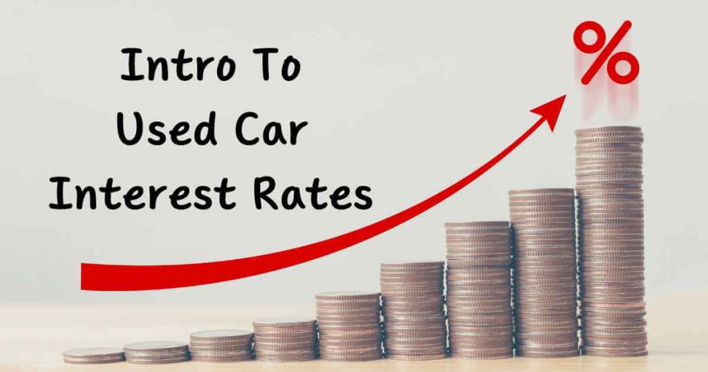 many stacks of coins like a bar graph and arrow that says "intro to used car interest rates"