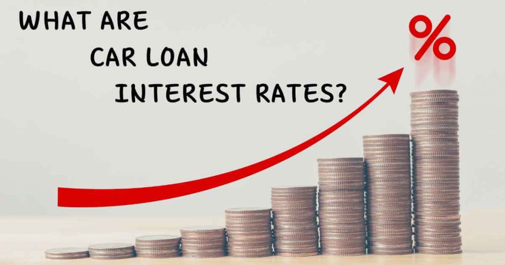 coins stacked as a bar graph with a red arrow pointing up and the words "what are car loan interest rates?"