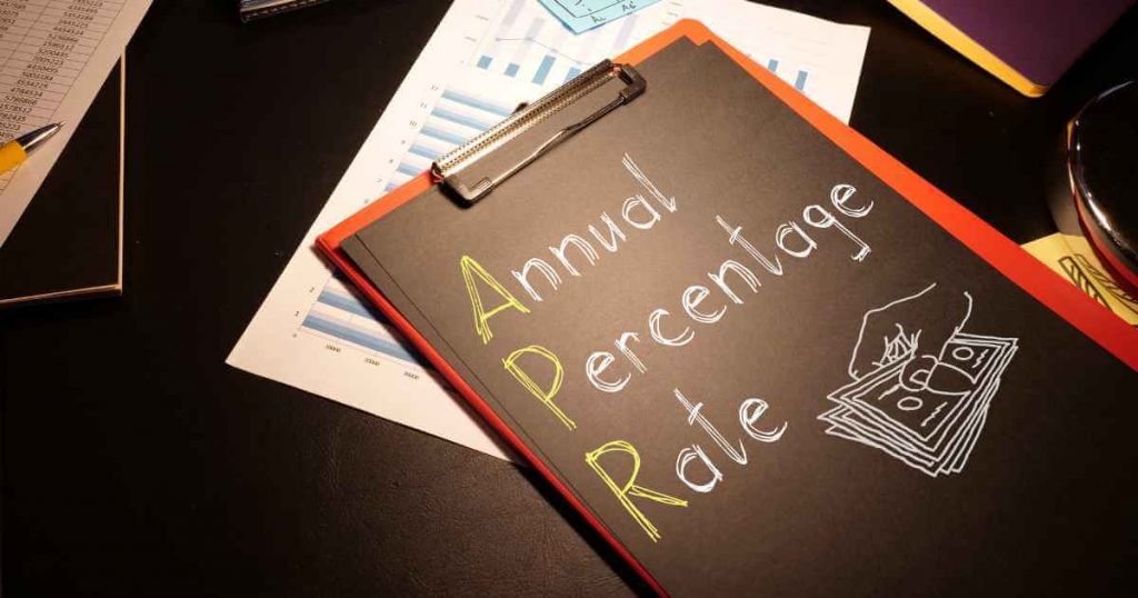 a clipboard with the a black paper on it that reads "annual percentage rate" for car loan APR