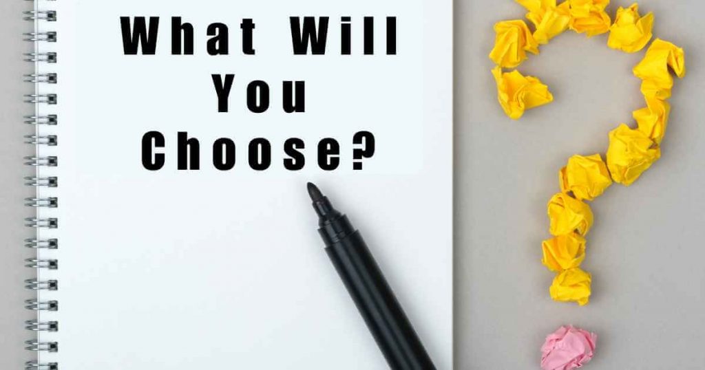 a notepad with the words "what will you choose", pen, and question mark made of crumpled sticky notes.